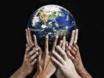 hands holding up the planet